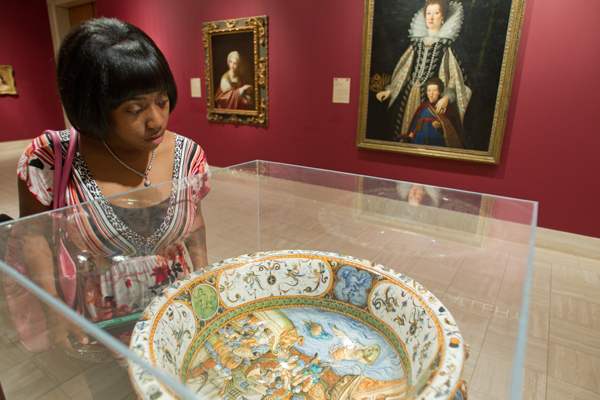 UM-Flint student examines artifact at Flint Institute of Arts