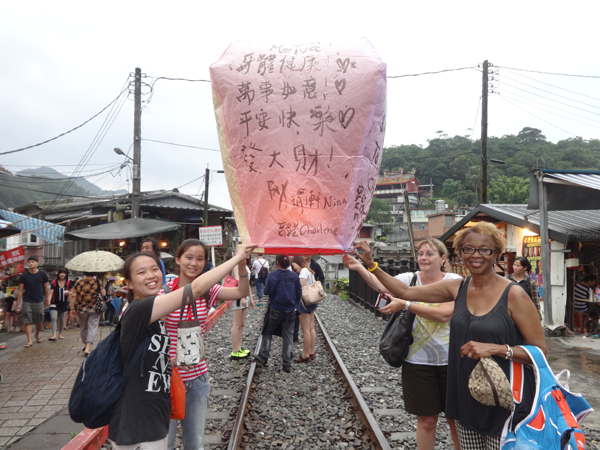 Melva Craft-Blacksheare and Judy Haefner help release a paper lantern.