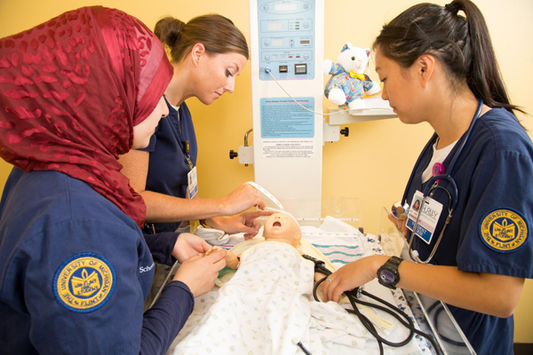 UM-Flint Nursing students utilize new infant care simulation technology.