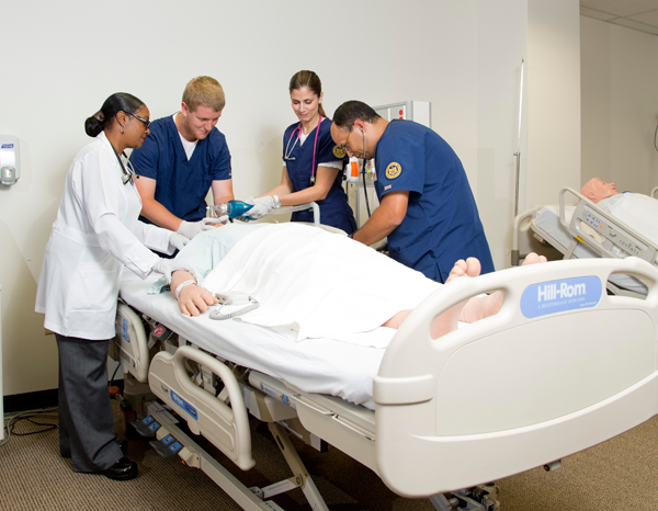 UM-Flint nursing students and instructors in simulation lab