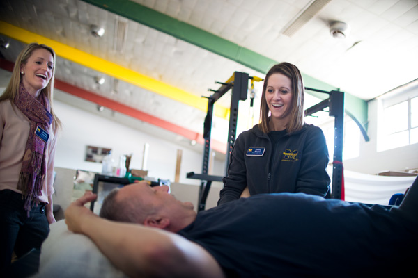 UM-Flint physical therapy students Alyssa Brennan and Kelsey Blegen treat Jim Schultz at PT Heart.