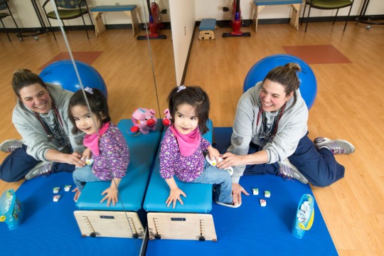 Dr. Susannah Steele, PT, DPT, PCS, works with a child at the Pediatric Rehabilitation Center-Commonwealth in Ann Arbor.
