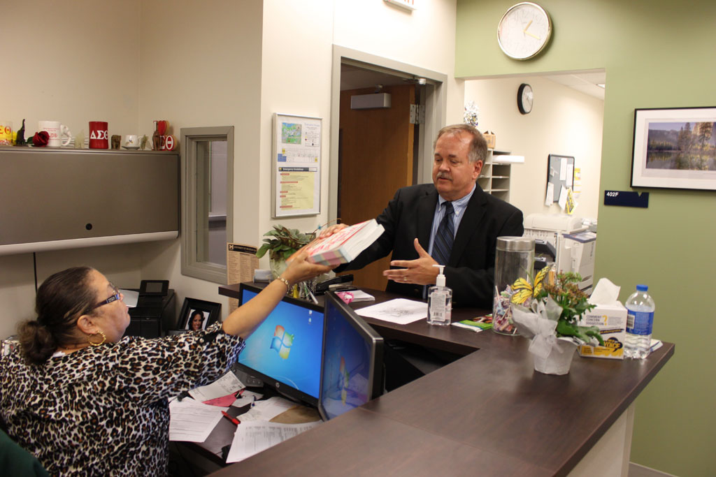 Dr. Wrobel picks up book donations from Lynn Barbee in the Mathematics Department.