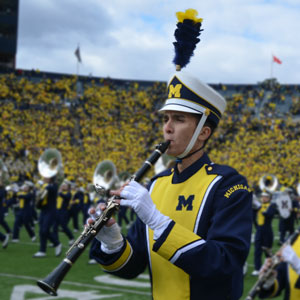 UM-Flint student Jacob Wright plays during halftime of a football game at "The Big House."