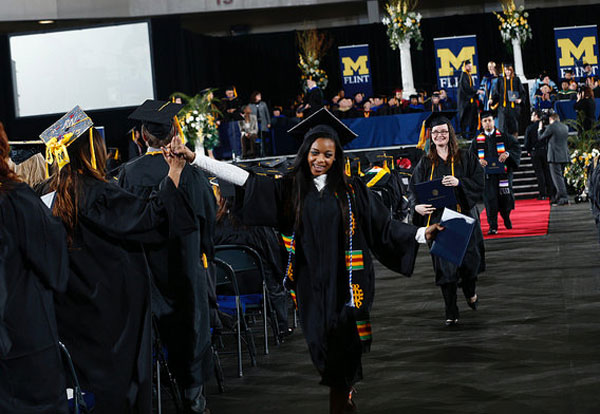 UM-Flint graduates high-five.