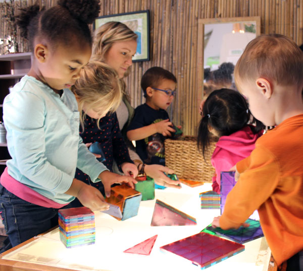 Light tables at the Early Childhood Development Center spark excitement among the children.