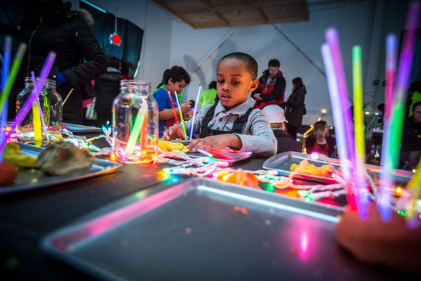 Kids playing with glow sticks at the 2015 Light Up the Night event.