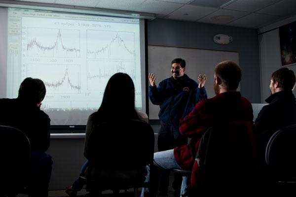 UM-Flint physics professor Rajib Ganguly, PhD discusses super-massive black holes with students.