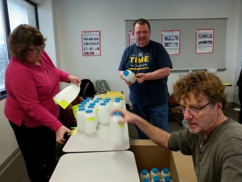 UM-Flint communication and visual arts professor Anthony McGill (center) helped coordinate student volunteers.