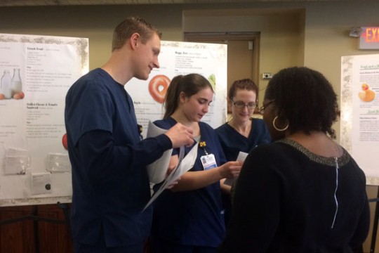 UM-Flint nursing students providing educational materials.