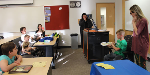 Colin Johnson reads to the group at the Reading Center celebration.