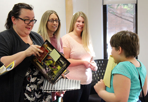 UM-Flint Literacy M.A. students presented each child with a new book.