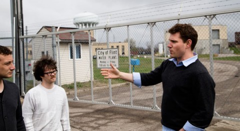 Jacob Abernethy, faculty advisor of the Michigan Data Science Team, talks with team members outside the Flint water plant during a team trip to Flint.