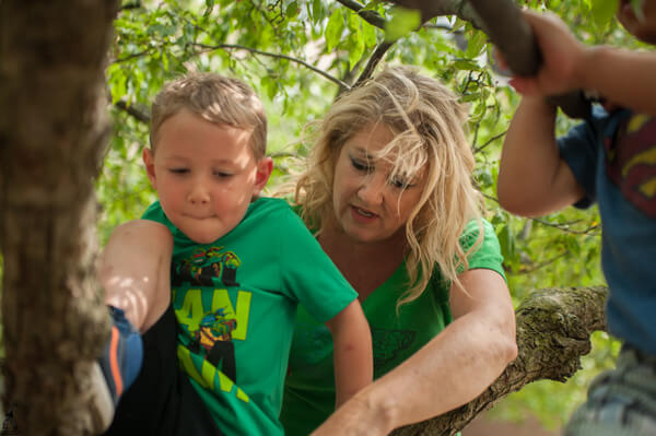 Mary Lynn Gottler and youngsters at UM-Flint's ECDC explore nearby nature. 