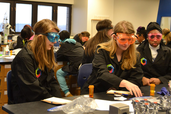 Curiosity Academy students conduct an experiment in a UM-Flint lab