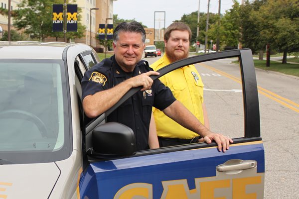 UM-Flint Public Safety Chief Ray Hall and student safety patrol member Matthew July.