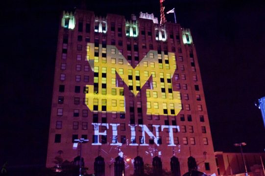 UM-Flint logo projected on Mott Foundation Building