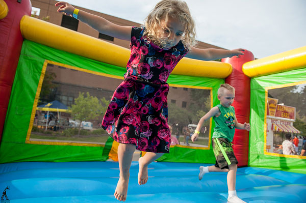 Children play in a bounce house on the UM-Flint campus