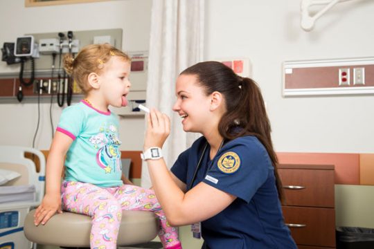 UM-Flint nursing student with young patient.