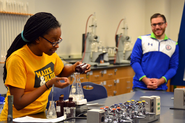 Lynnette Harris and Noor Alawwa of the UM-Flint Chem Club conduct a demo for visiting high schoolers.