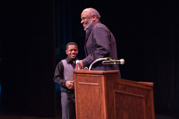 Eric Lynn, winner of the district-wide fourth grade spelling bee at Flint Community Schools, introduced Mr. Curtis in the morning session.
