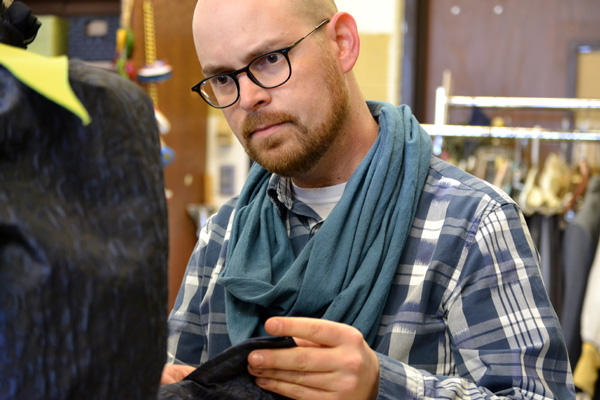 Adam Dill of UM-Flint Theatre working in the university's Costume Shop