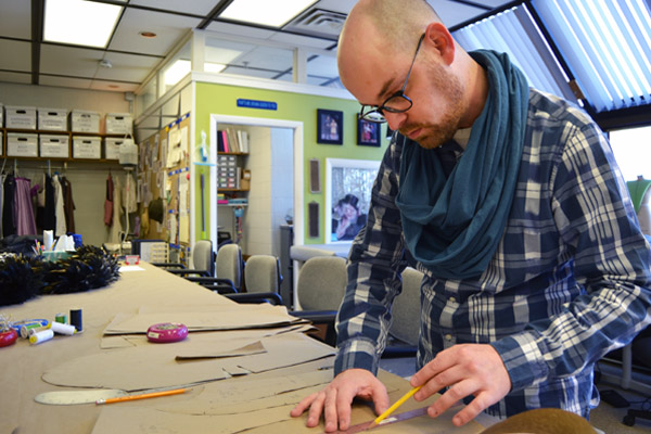 Adam Dill of UM-Flint Theatre working in the university's Costume Shop