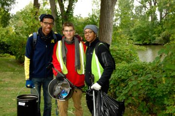 Zach Hayes (center) will fellow FUEL members at a Flint River cleanup.