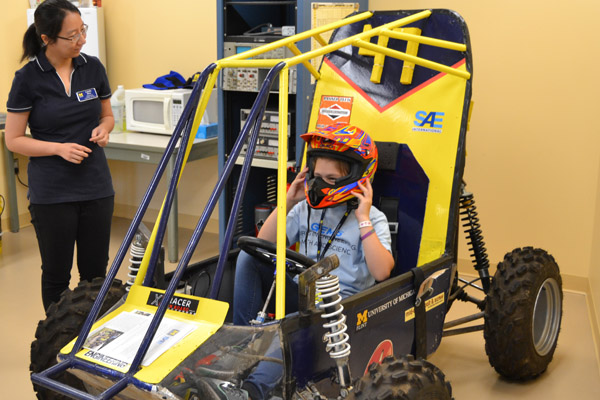 A GEMS participant sits in UM-Flint engineering's Baja Racer