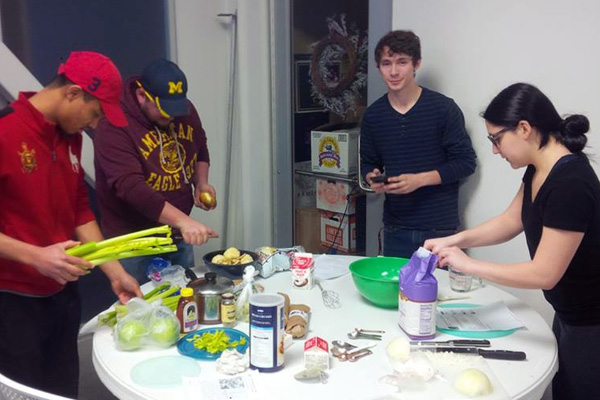 Students preparing a meal for their final exam in UNV 100: Food and Culture