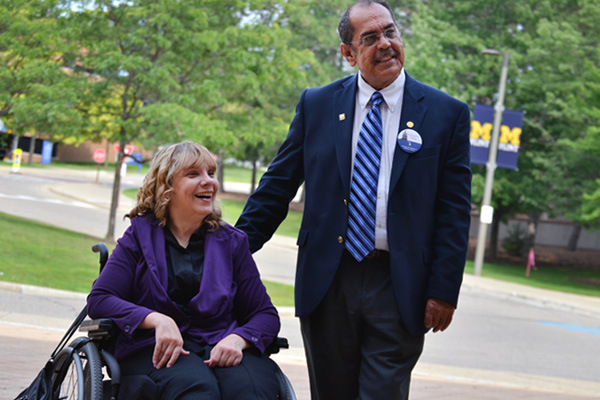 Charlene Lizotte (left) stands with State Representative Tim Sneller (right) on the UM-Flint campus