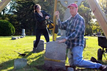 UM-Flint History professor Thomas Henthorn and students at Old Calvary Catholic Cemetery.