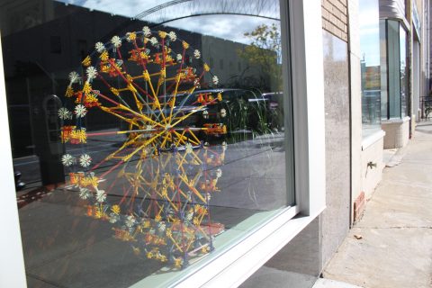 A model ferris wheel in the window of the Ferris Wheel Building.