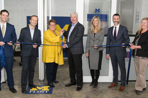 Governor Snyder and Lt. Governor Calley join UM-Flint's Chancellor Susan E. Borrego and University Outreach staff members to cut ribbon at Ferris Wheel Building.