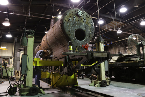 Uriah Horton of UM-Flint Engineering working on 1920 Baldwin Steam Locomotive #152 at Crossroads Village 