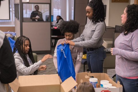 MLK Day volunteers assemble care packages for area homeless.