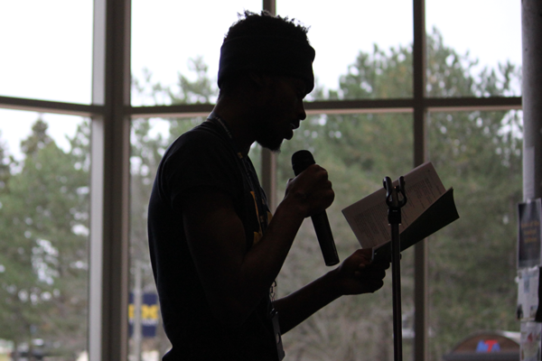 A UM-Flint student performs at an open mic event on campus.