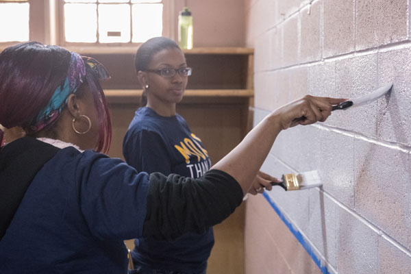 Student volunteers painting at Joy Tabernacle in Flint.