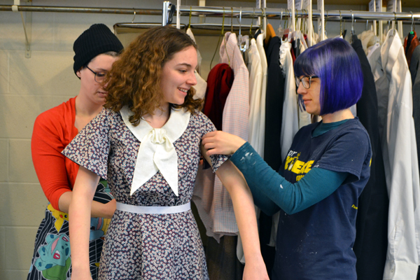 Borton (right) works with Design & Technology student Alli Switalski to put finishing touches on Devon Marinco's costume.