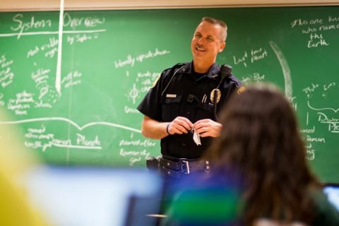 A UM-Flint public safety officer meeting with campus.