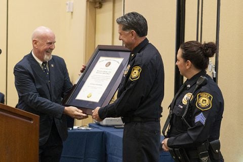 UM-Flint’s Department of Public Safety is presented with a plaque recognizing its accreditation by the Michigan Law Enforcement Accreditation Commission (MLEAC).