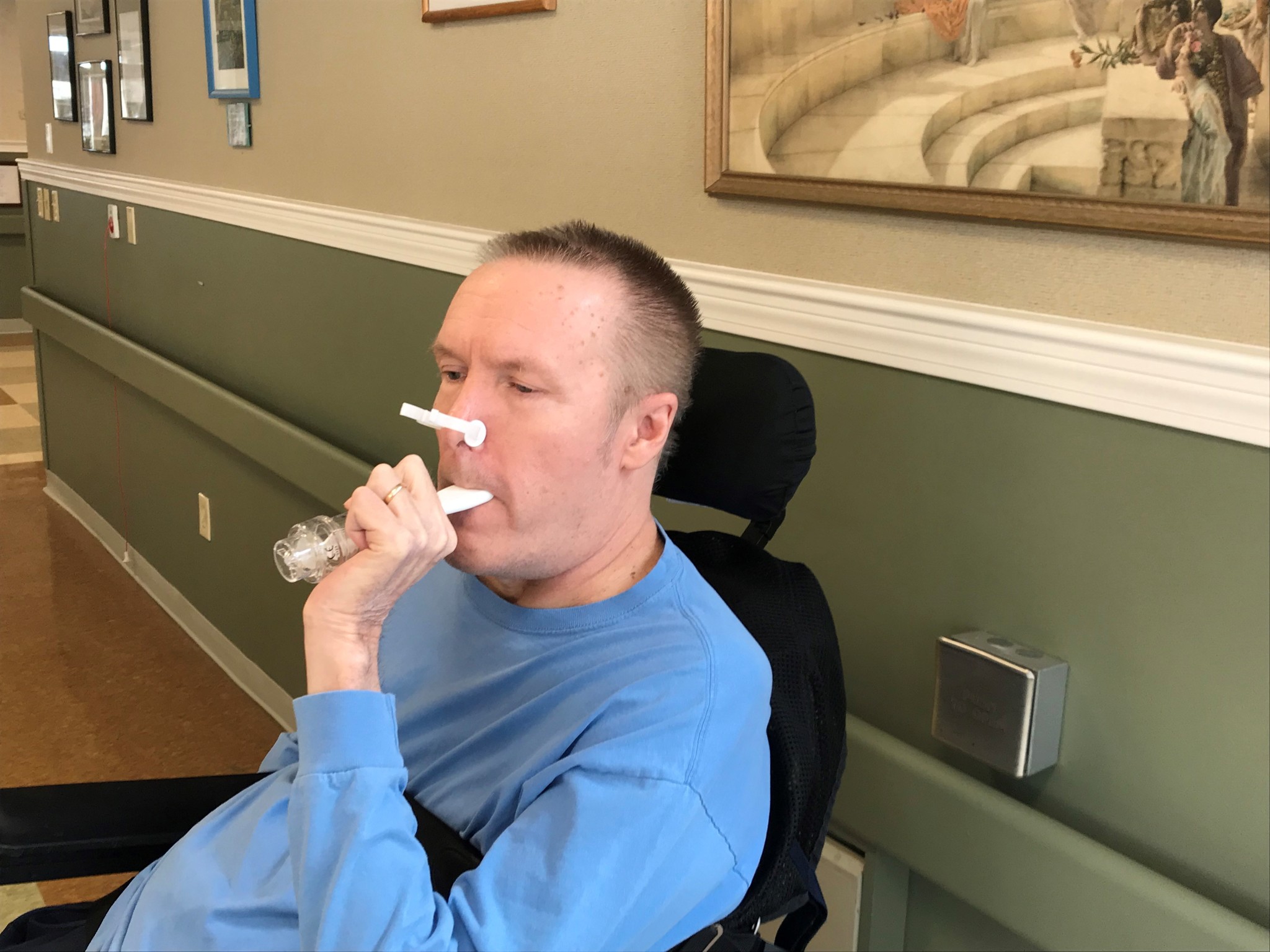 A resident of The Boston Home does respiratory exercises