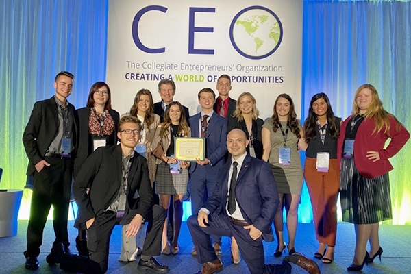 Members of the UM-Flint Entrepreneur Society gather for a group photo at a conference.