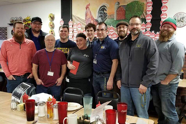 Staff members from our office of information technology services gathered at a restaurant with a local waitress holding a very generous tip