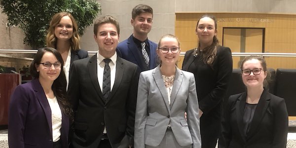 UM-Flint's Moot Cour team, comprised of seven students dressed in suits