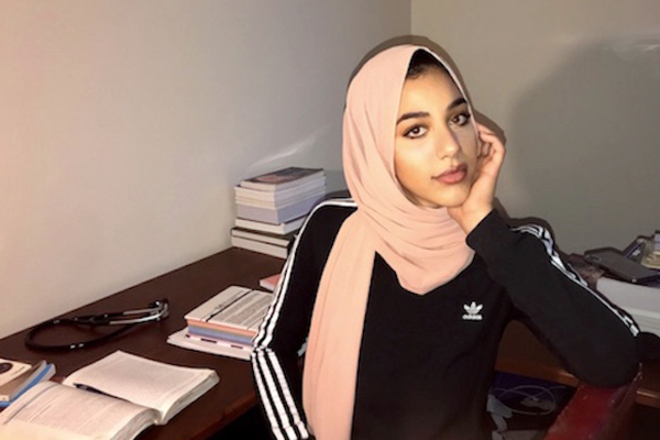 UM-Flint alumna Yousra Mohamed '19 poses for a portrait.