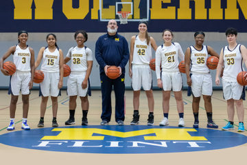 Seven members of the UM-Flint Women's Club Basketball Team and their coach pose for a portrait in the Recreation Center.