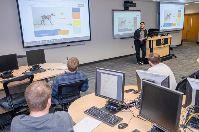 A class Assistant professor of Computer Science Zahid Syed and students in a cyber classroom. (Photo by Logan McGrady, College of Arts and Sciences)being held in a cyber classroom