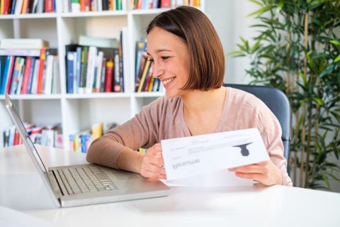 Cheerful girl writing job resume on the computer for recrUM-Flint experts say the current situation in our workplaces may change the way business is handled in the future.uiting advertisement