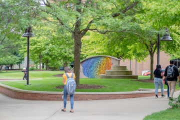 Students walk on UM-Flint campus in the spring
